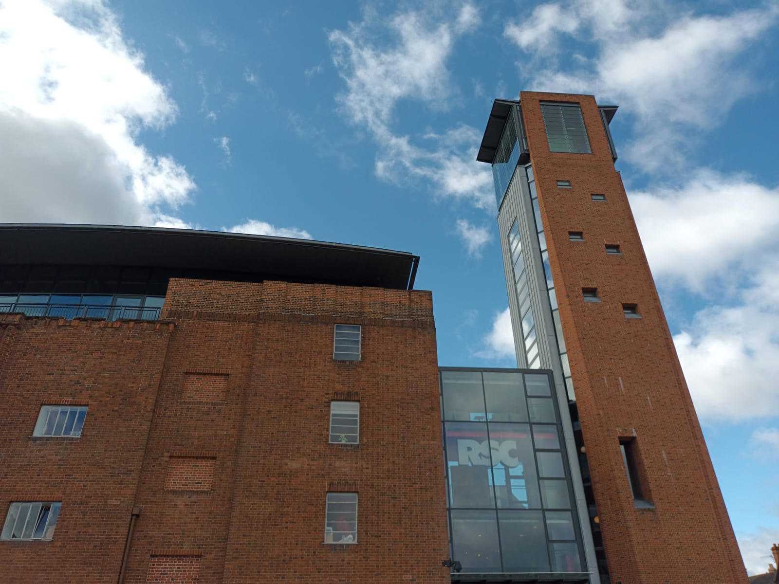 The brick facade of the Royal Shakespeare Theatre beside the River Avon