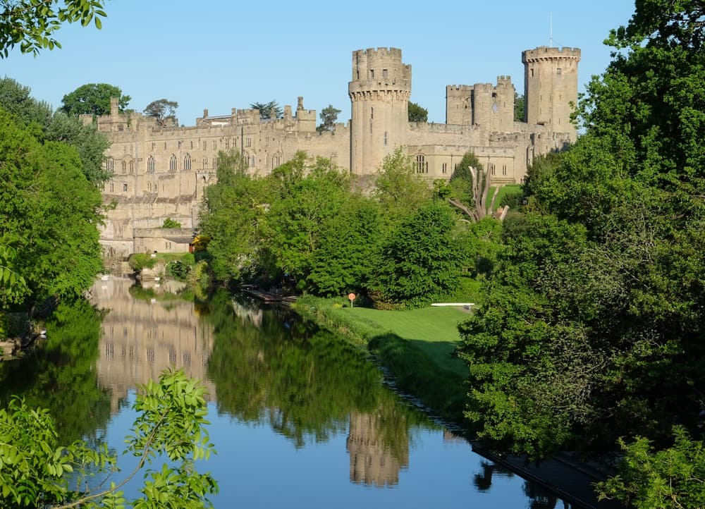 The towers and battlements of Warwick Castle above the River Avon